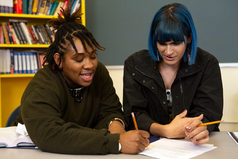 Two non-binary-students doing-work together in class. // Photo from The Gender Spectrum Collection / Zackary Drucker
