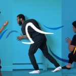 Three people dance in an illustrative photographic image with lines drawn over their movements.