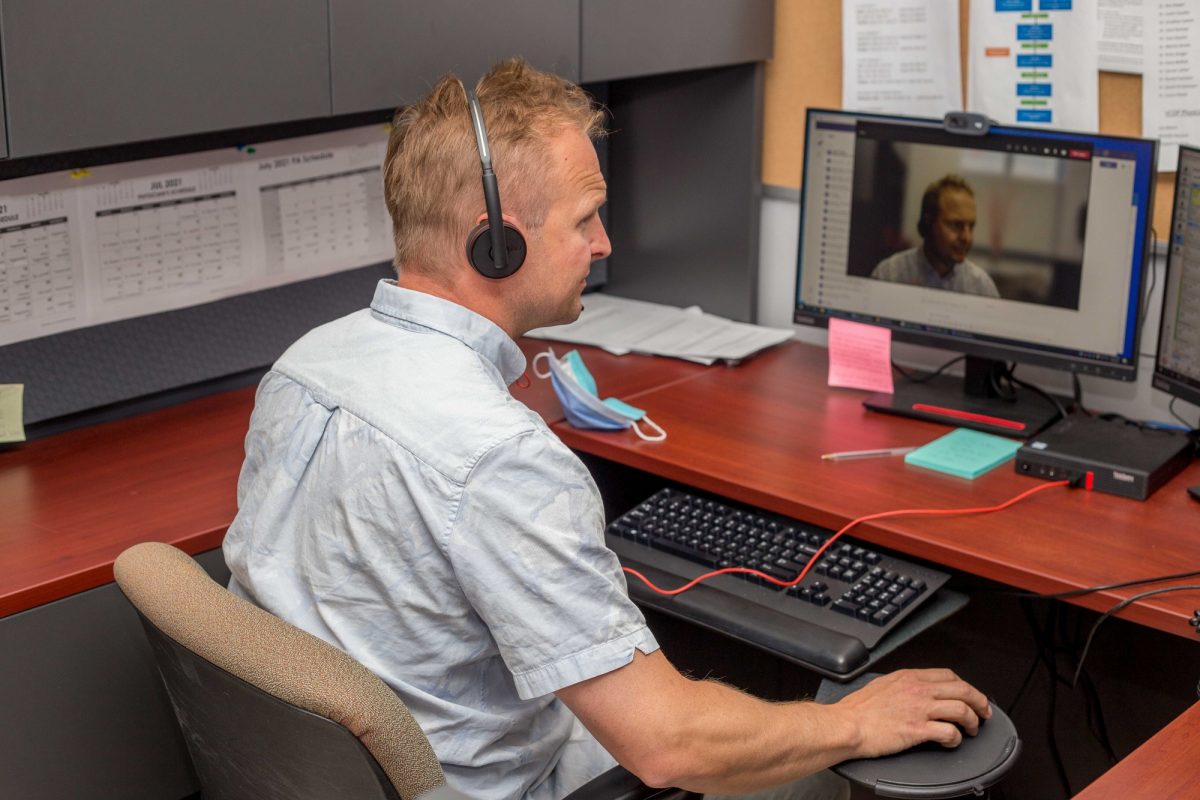 A physician who is part of the VCOP team speaks with a patient remotely.