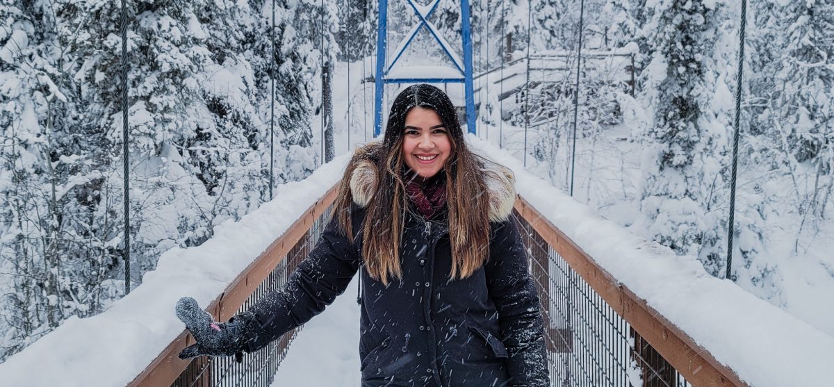 Taylor Antonchuck Emerging Leader Award recipient Faculty of Law smiling in winter on a suspension bridge.