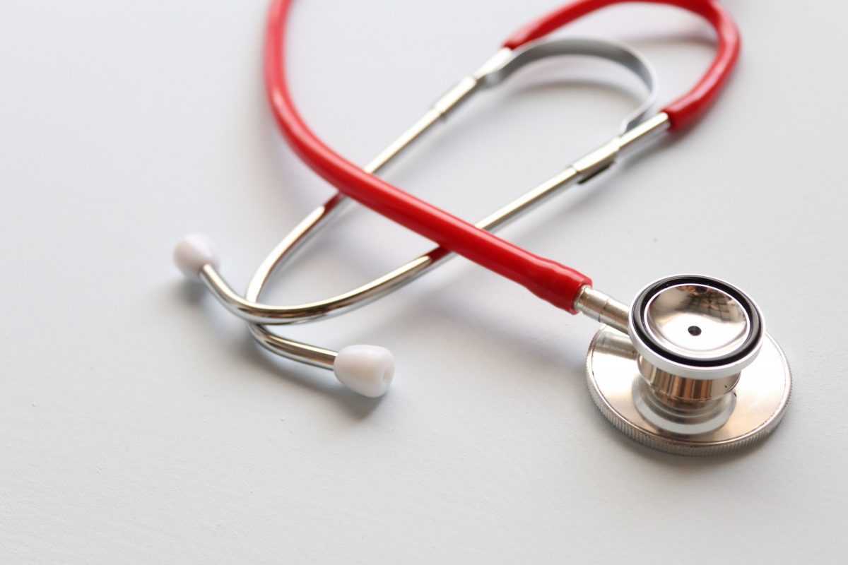 Red stethoscope on table.