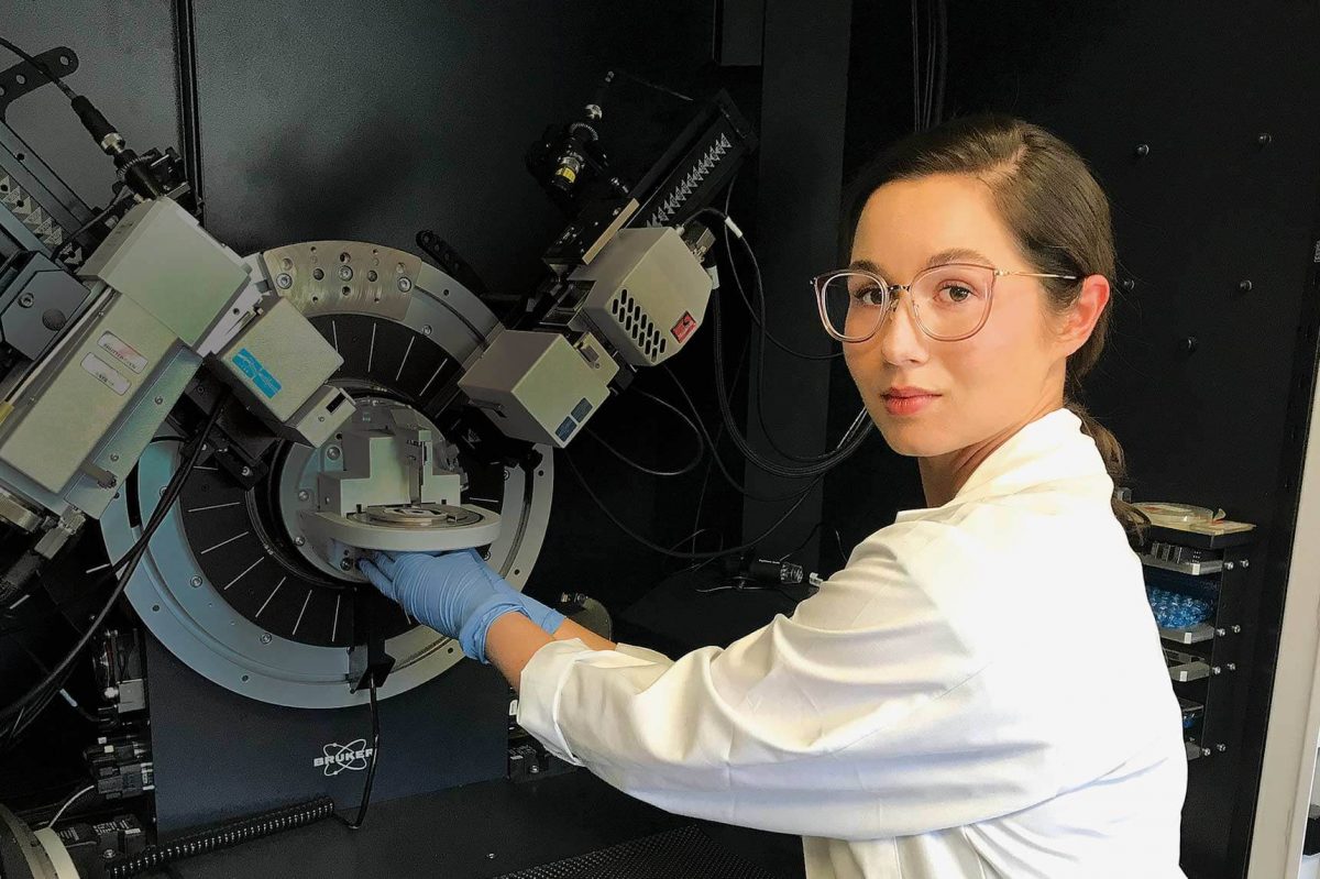 Rachel Nickel poses with a large scientific device.