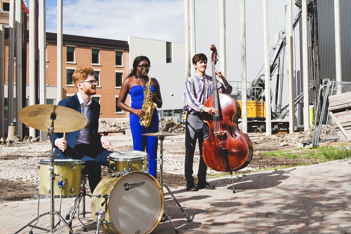 Desautels Faculty of Music students Josh Bonneteau (drums), Joyce German (saxophone) and Sam Fournier (bass) perform on the future concert hall site.