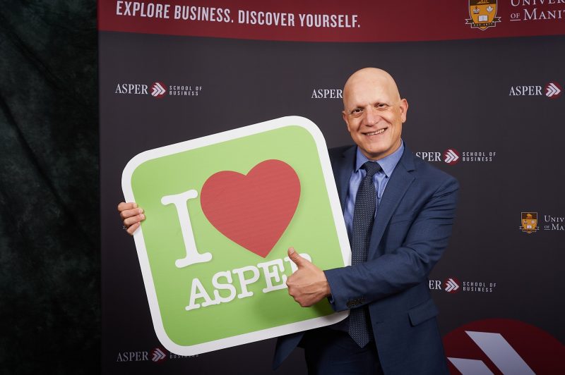 Gady Jacoby holding an Iheart asper sign.