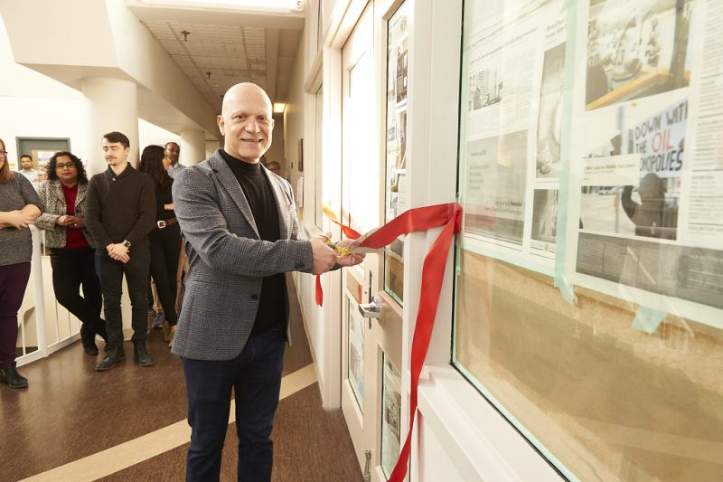 Gady Jacoby cutting a red ribbon for a room opening