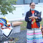 Knowledge Keeper Leslie Spillett speaks near the sacred fire and spirit chair at the Honouring Our Children ceremony.