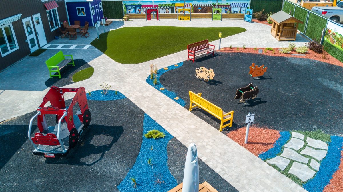 A children's play park designed with mini roads and traffic signs to teach road safety to young kids.