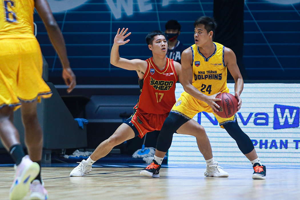 Binh Nguyen plays defense against a player holding the ball.