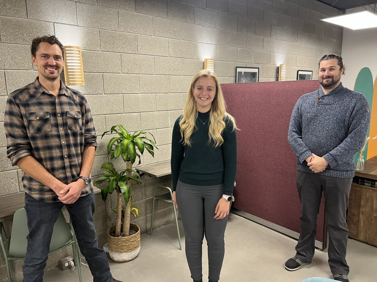 Young Friends of Engineering founding members Derek Neufeld, Katie Moist and Dan Nenadov stand socially distanced smiling and posing for the camera.