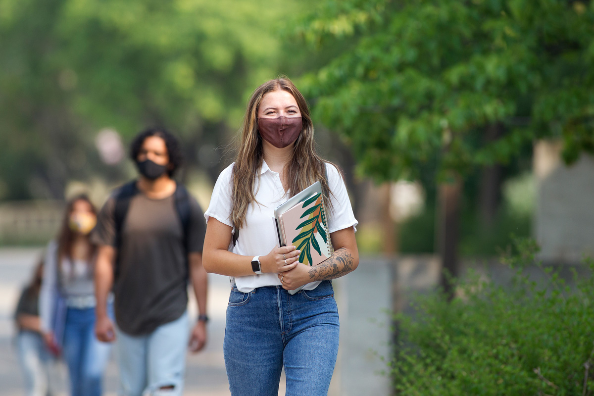 Students in masks walking on the Fort Garry campus