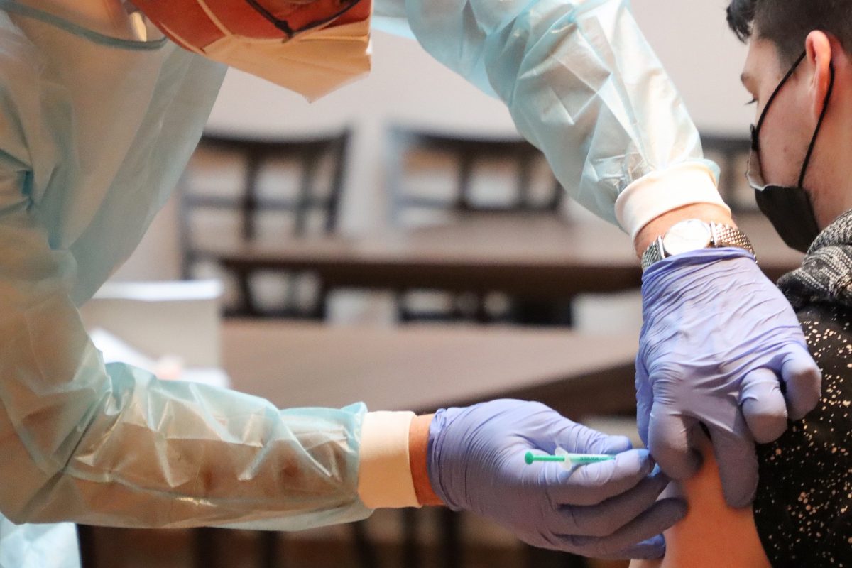 A young person receiving a COVID-19 vaccination