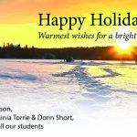 Holiday greetings with image of winter scene with footprints in snow leading off to a sunset