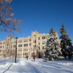 Students walking on Fort Garry campus in winter, near Buller Building.