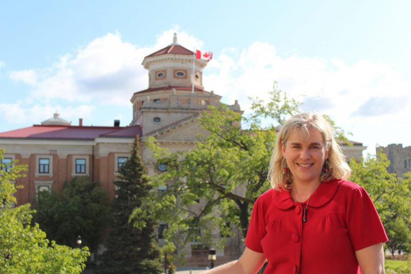 Photo of Kelley Main in front of Admin building