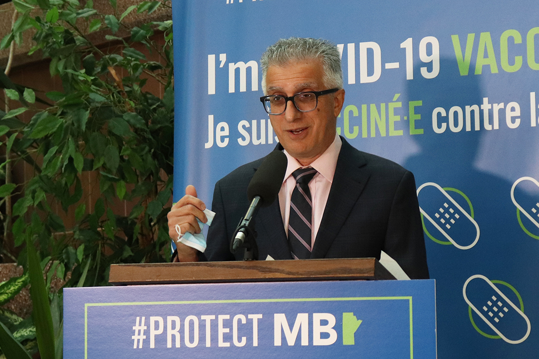 Michael Benarroch speaks at a lectern.