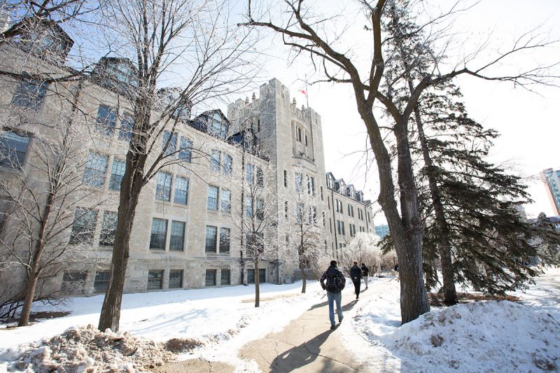 Students walk the path in front of Tier Building on Fort Garry campus in winter 2020.
