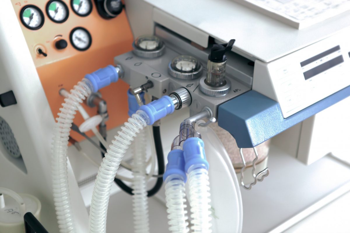 A close-up of a ventilator with tubes running into it.
