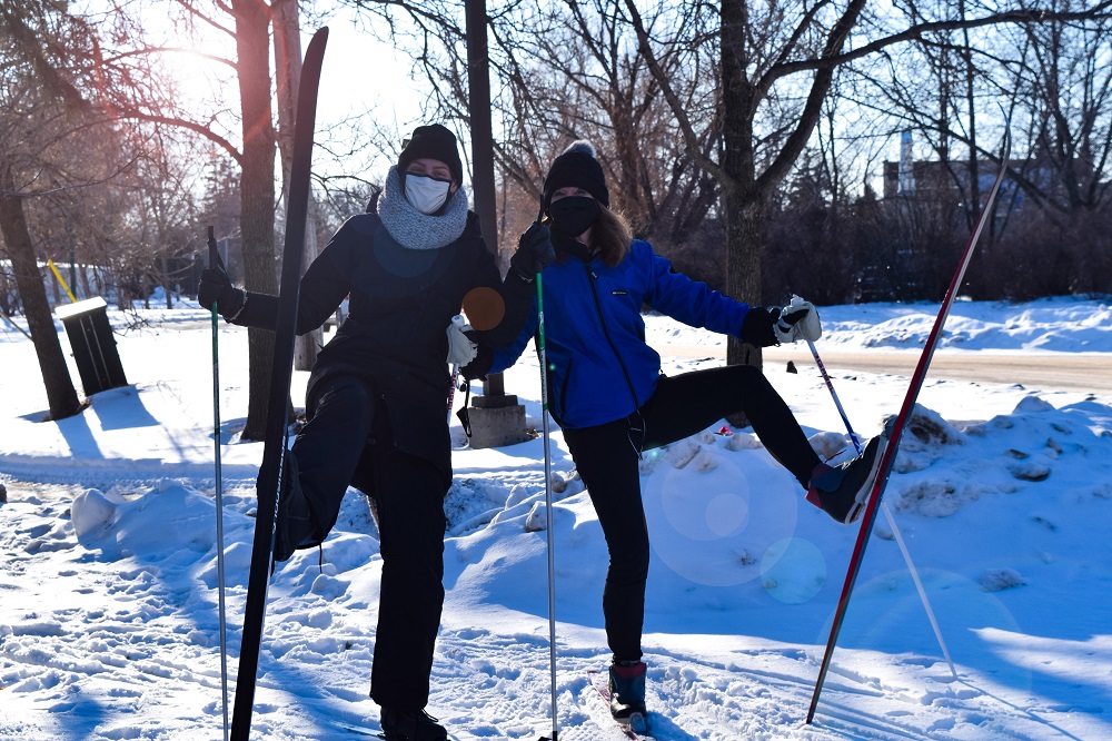 Two UM staff members posing while cross country skiing on Fort Garry campus.