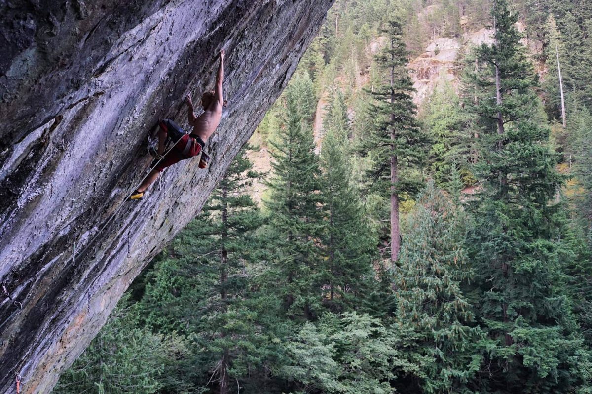 student climbing on side of mountain