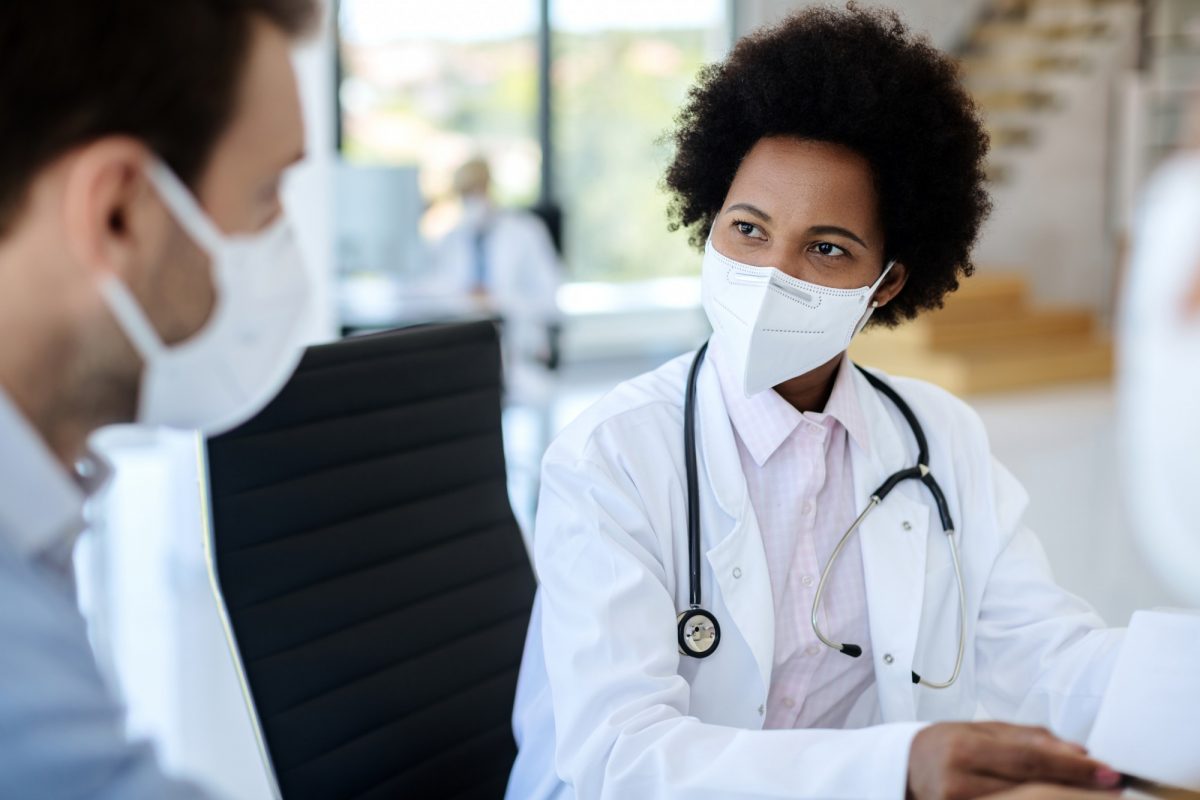 doctor speaks with patient