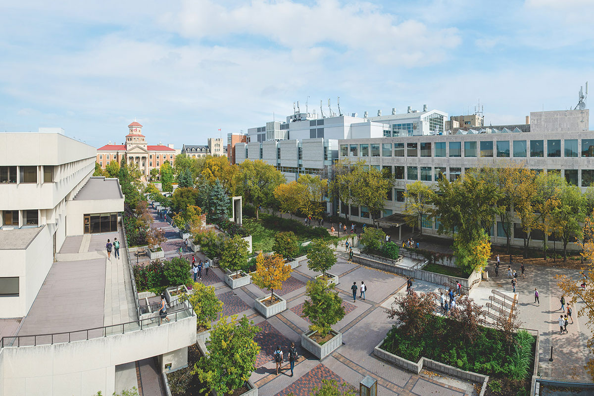 An aerial look of Fort Garry campus buildings and people walking on walkways.