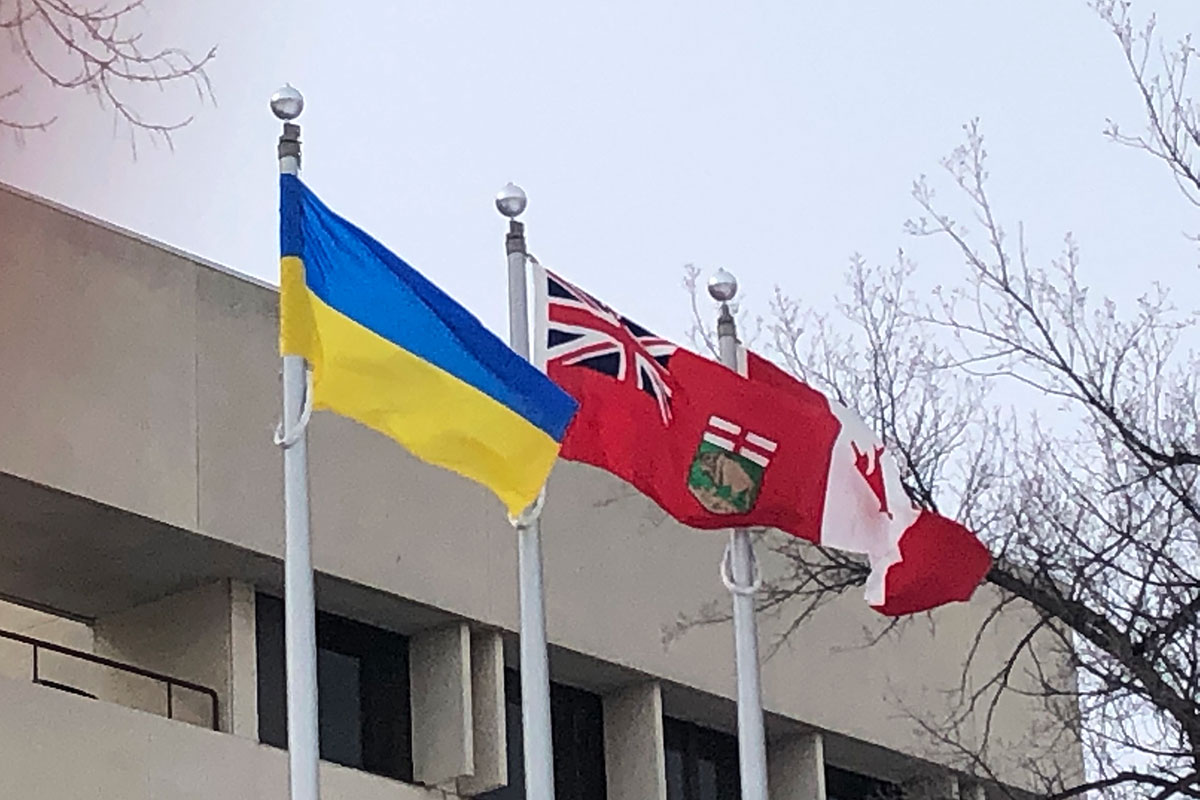 The Ukraine flag next to the Manitoba flag and the Canadian flag on Fort Garry campus. The Ukraine flag was raised on March 10, 2022, outside of UMSU University Centre. // Photo from Donna Rutkowski