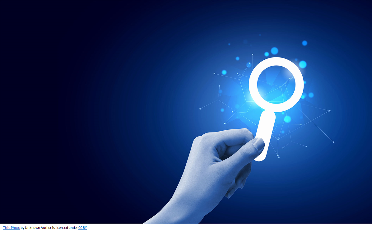 Hand holding magnifier looking at network data.