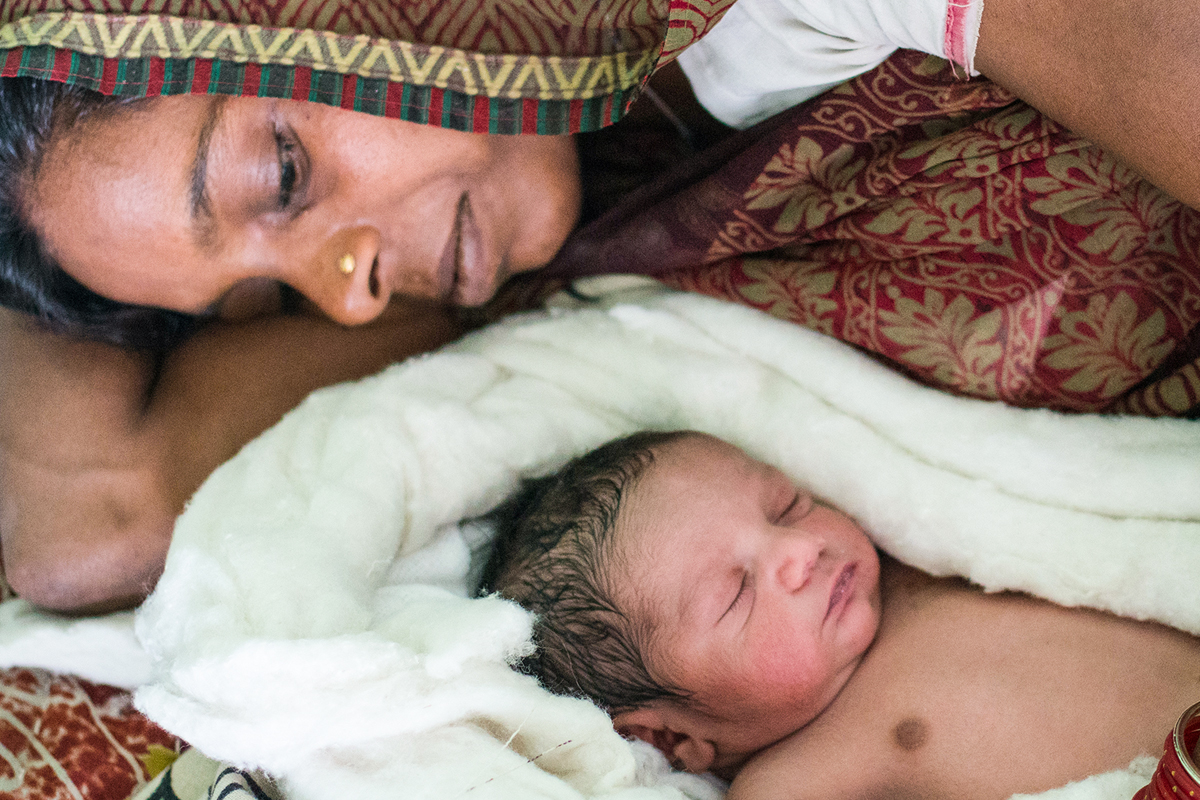 Mother looks at her new born baby.