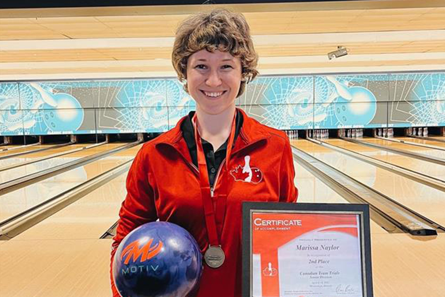 Marissa Naylor stands with a bowling ball and a certificate after placing 2nd in the Team Canada tenpin bowling trials