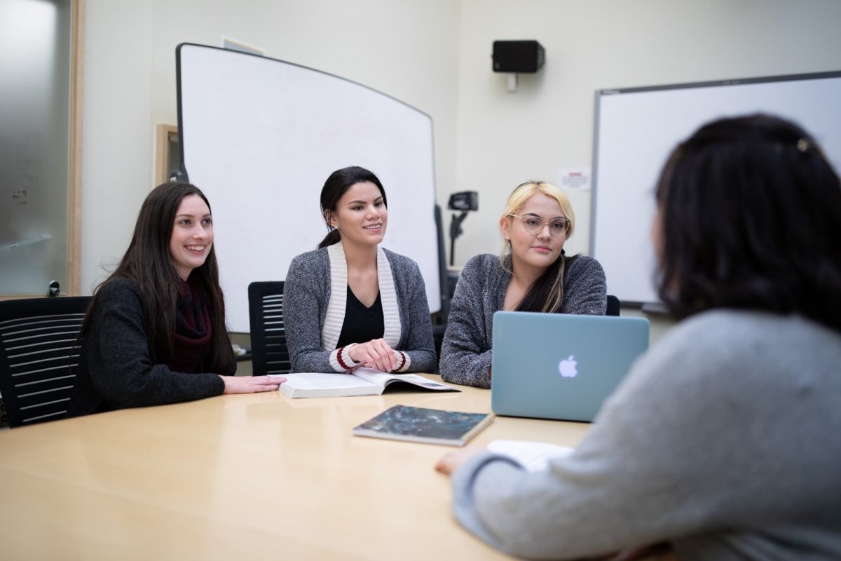 Indigenous students meeting around a table.