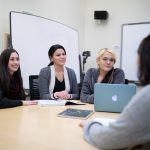 Indigenous students meeting around a table.