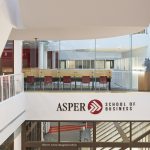 View from the third floor of the Drake Centre. Looking from the balcony, across the way is a study area with glass around it and a sign that says Asper School of Business.