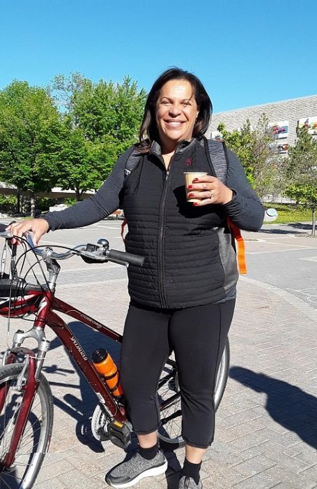 Naomi Andrews, VP Administration, enjoys refreshments after arriving at Fort Garry Bike to Work Day pit stop.