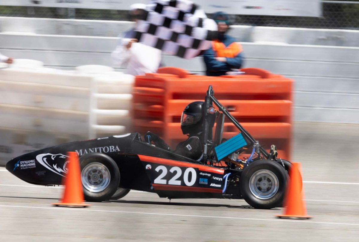 A UMSAE formula car being driven by a student