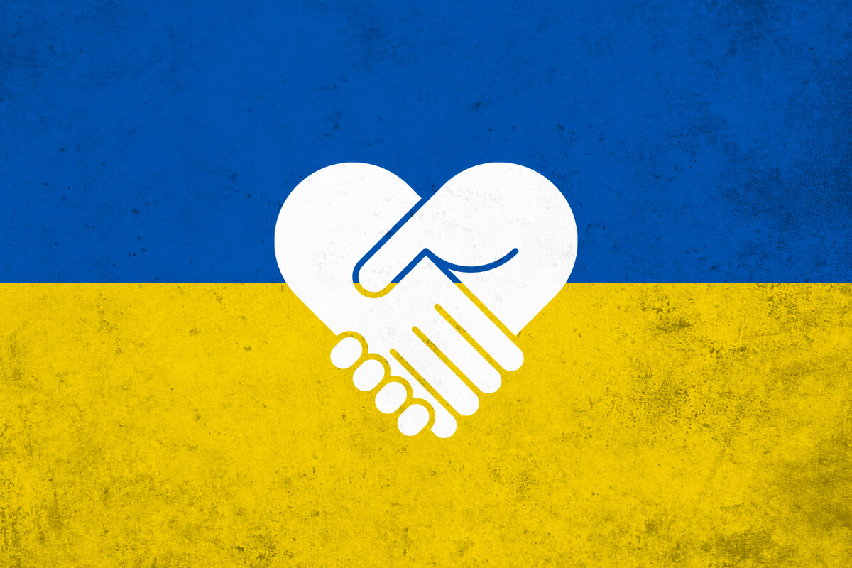 A Ukrainian flag superimposed with two hands shaking in the form of a heart.