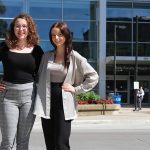 Student researchers Catherine Campos and Samantha Prokopich stand outside the Brodie Centre at Bannatyne campus.