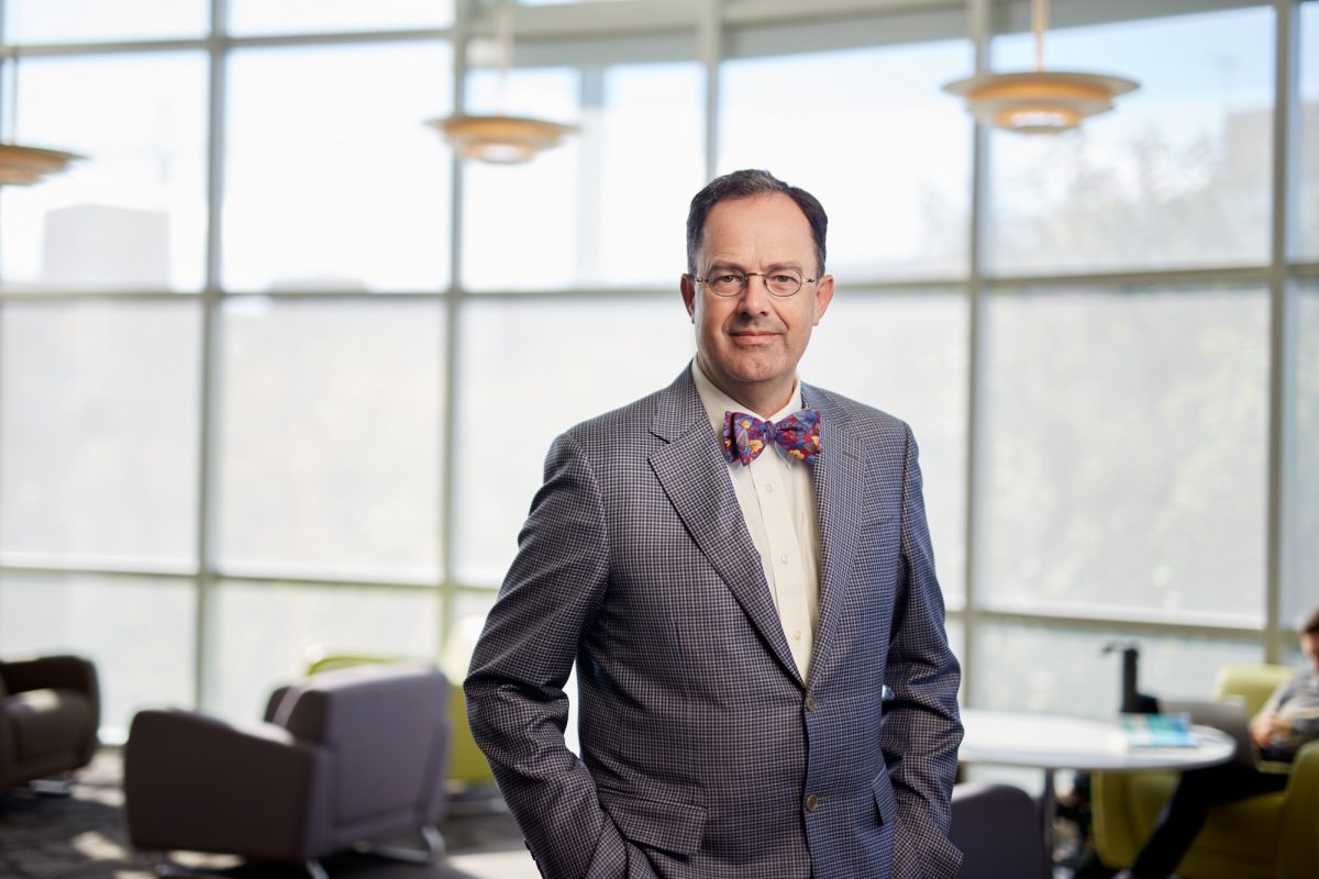 Peter Nickerson in a suit in front of windows