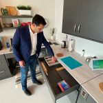 Dr. Amine Choukou looks into an open drawer in the smart suite kitchen.