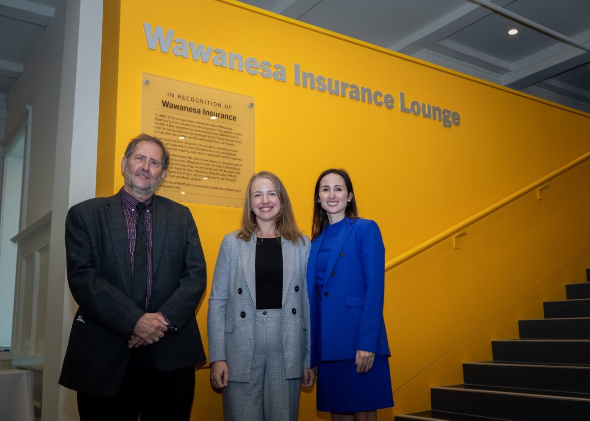 Dr. Ed Jurkowski, Vanessa Koldinges and Susan Hinds stand in front of new sign.