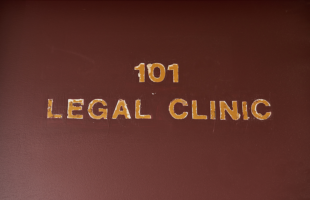 Close up image of door sign that says 101 Legal Clinic