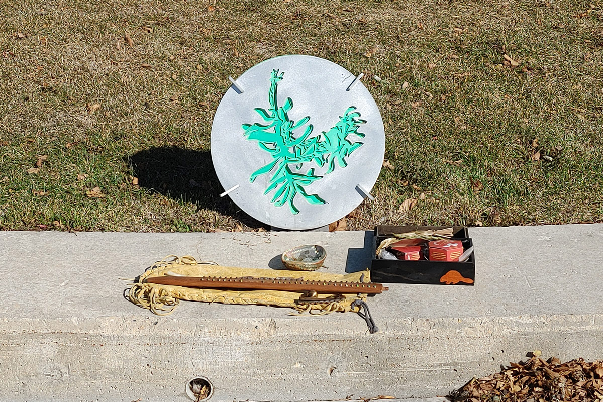 A metal wayfinding plaque installed on UM's Fort Garry campus to point in the four cardinal directions. // photo courtesy of Brian Rice