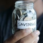 money in a jar marked "savings"