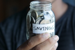 money in a jar marked "savings"