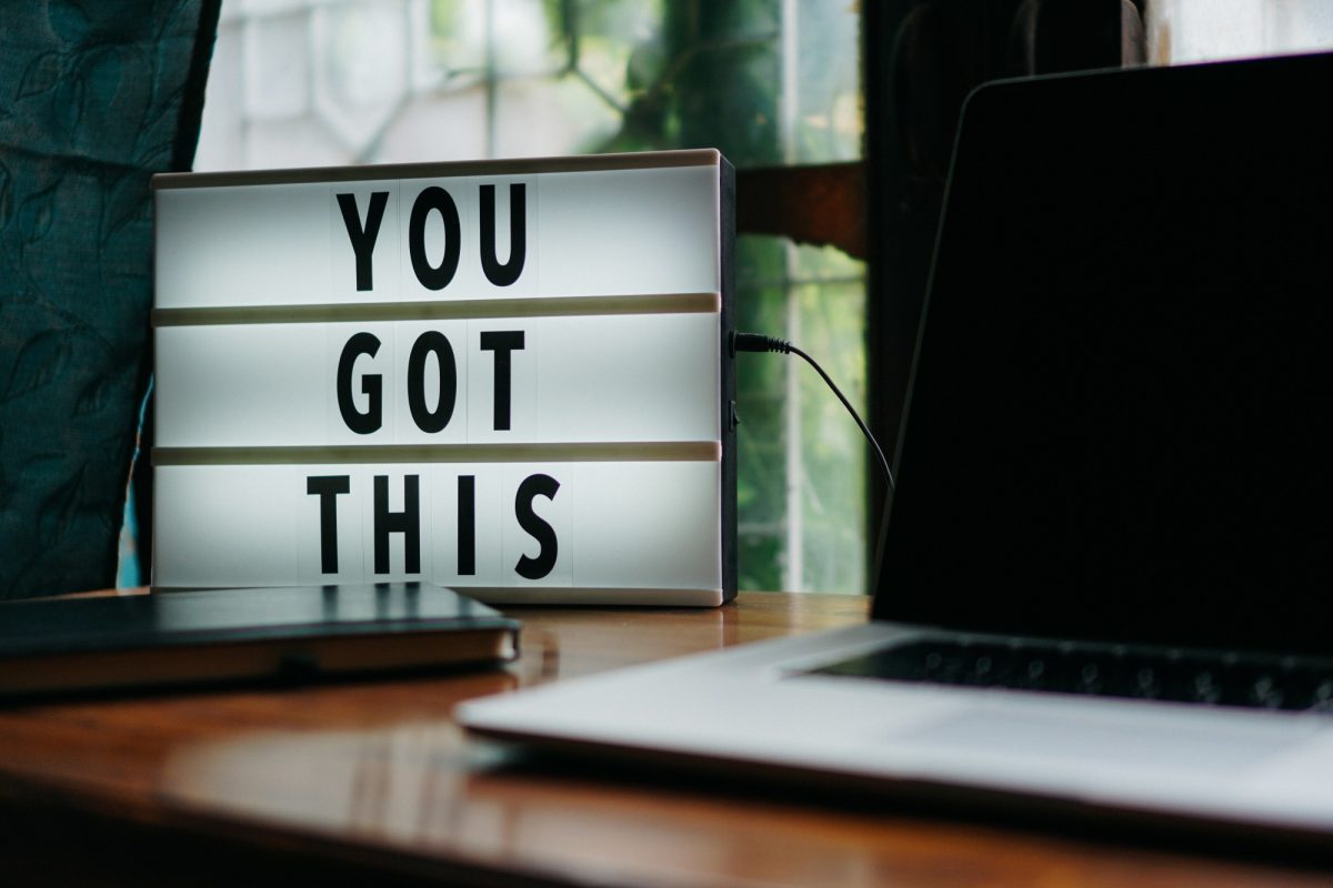A lightbox sign on a desk reads "You got this"
