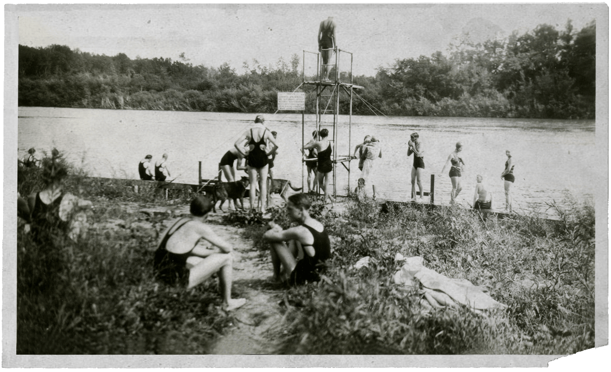 A historic black and white photograph of students swimming in vintage swimsuits.