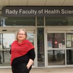 Gayle Halas in front of the Rady Faculty of Health Sciences