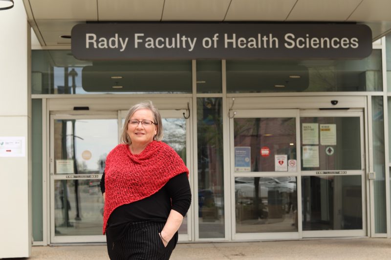 Gayle Halas in front of the Rady Faculty of Health Sciences