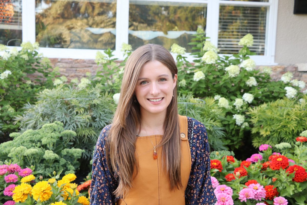 Sasha Kullman in front of flowers