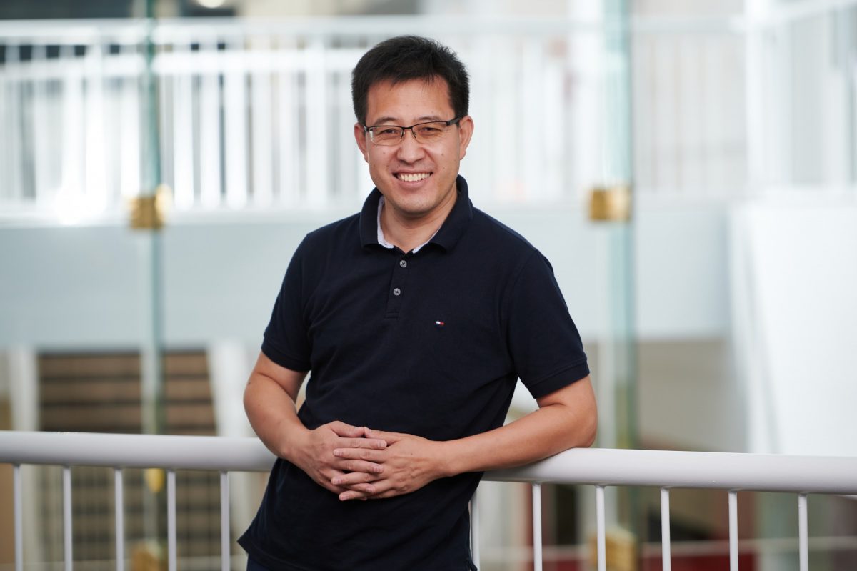 Man standing in front of a railing