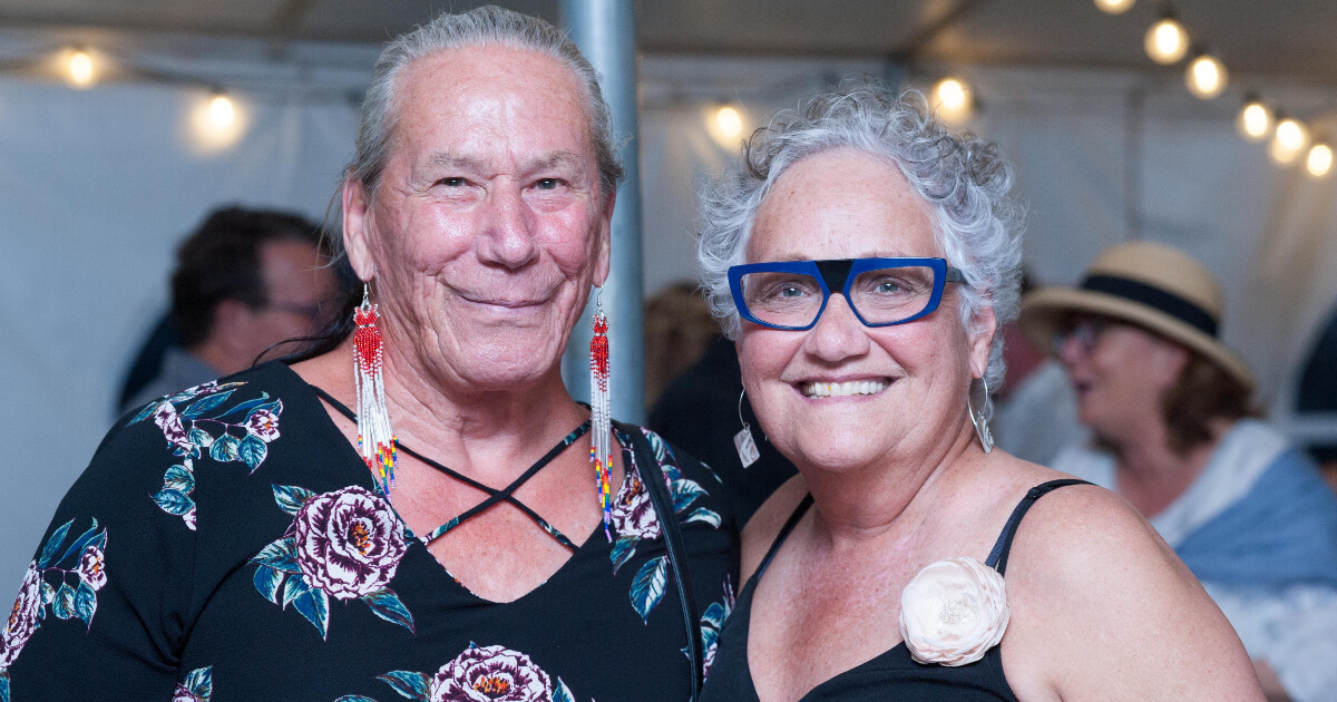 Two Two-Spirit leaders posing for a photo at an event.